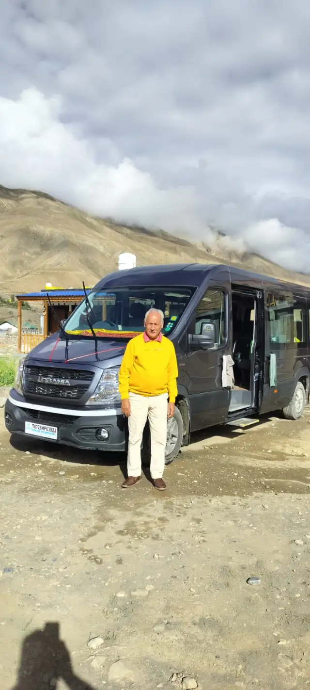 Senior guest standing in front of the Gemini Urbania with its door open